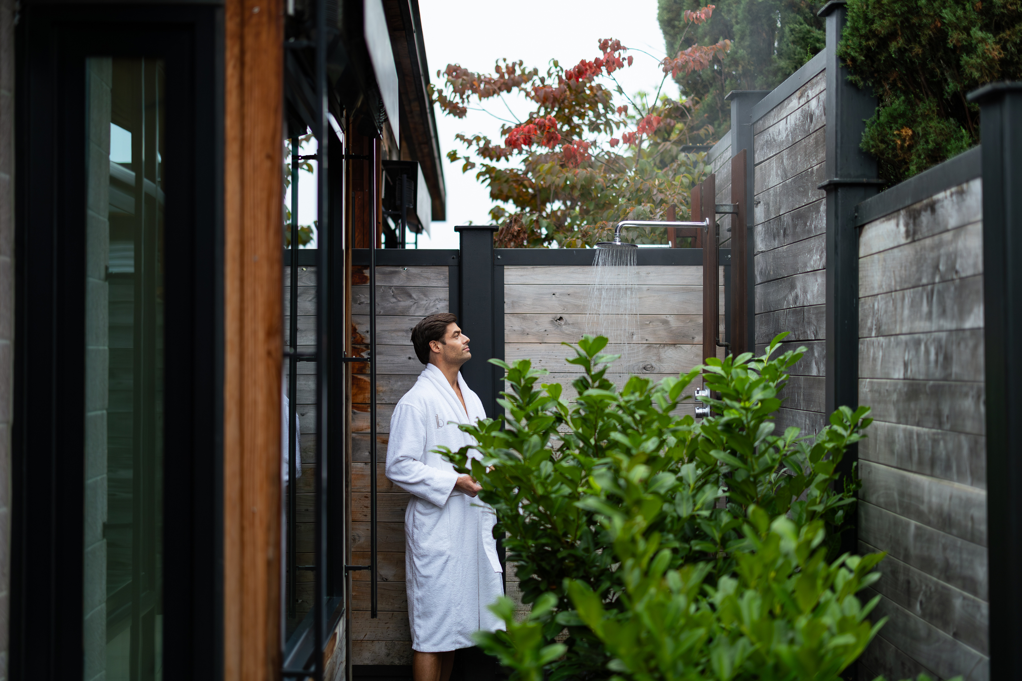 a man standing outside in a white robe