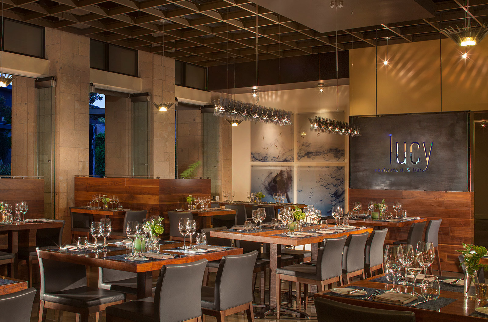 a restaurant dining area with multiple tables set for dinner