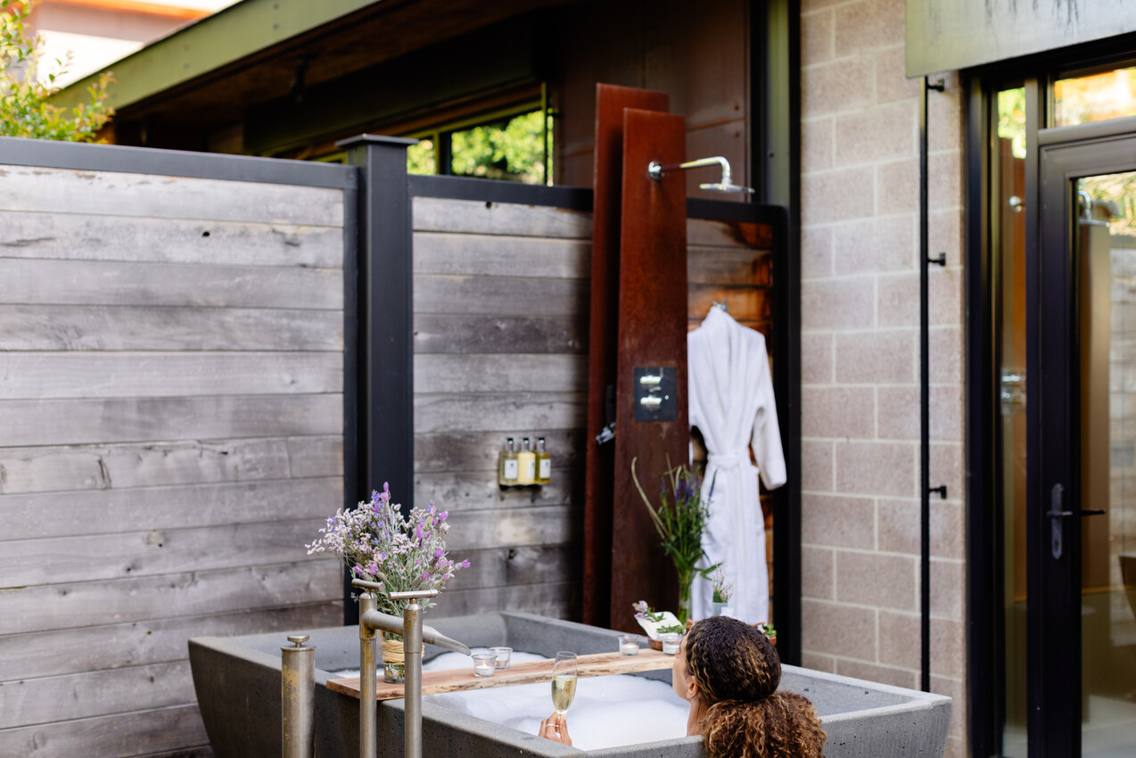 a woman sitting in a bathtub outside